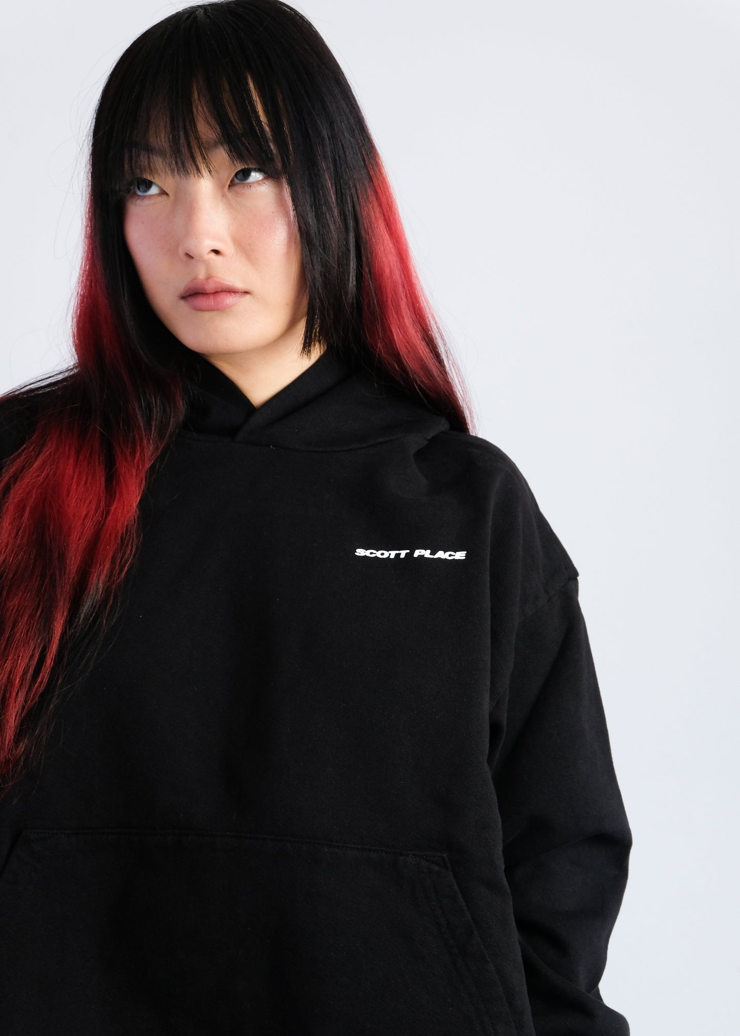 Person wearing a black hoodie with 'Scott Palace' logo on a white background